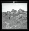 Osada cikánských domků - v popředí venkovní latrína v krajině